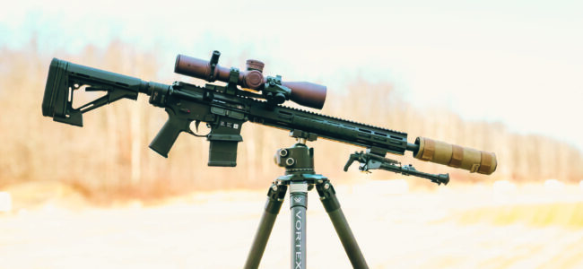 Zion-15 SPR with scope and suppressor positioned on tripod